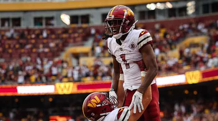 Sep 11, 2022; Landover, Maryland, USA; Washington Commanders wide receiver Jahan Dotson (1) celebrates with tight end John Bates (87) after catching the game winning touchdown against the Jacksonville Jaguars during the second half at FedExField.